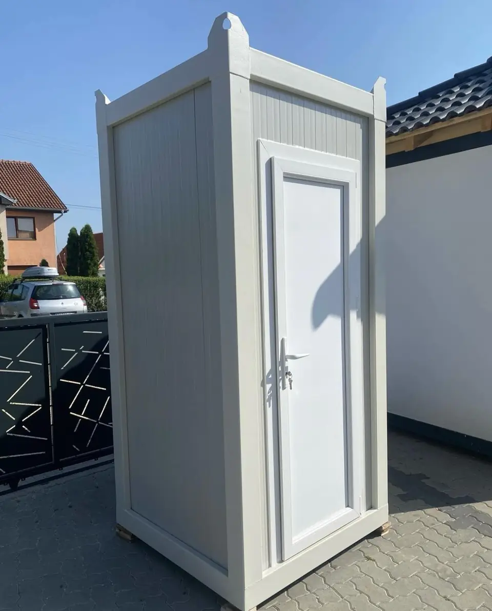 Side view of a white deluxe portable restroom