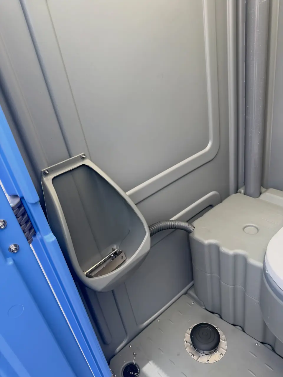 Close-up of the urinal inside a standard portable toilet
