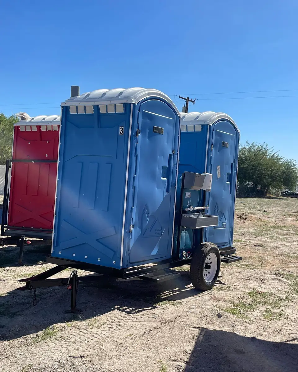 Porta potties mounted on a small towable trailer